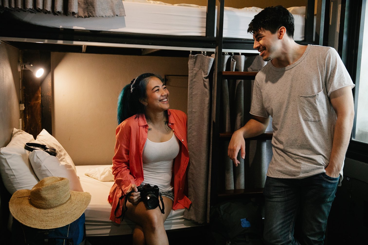 Cheerful diverse couple in hostel