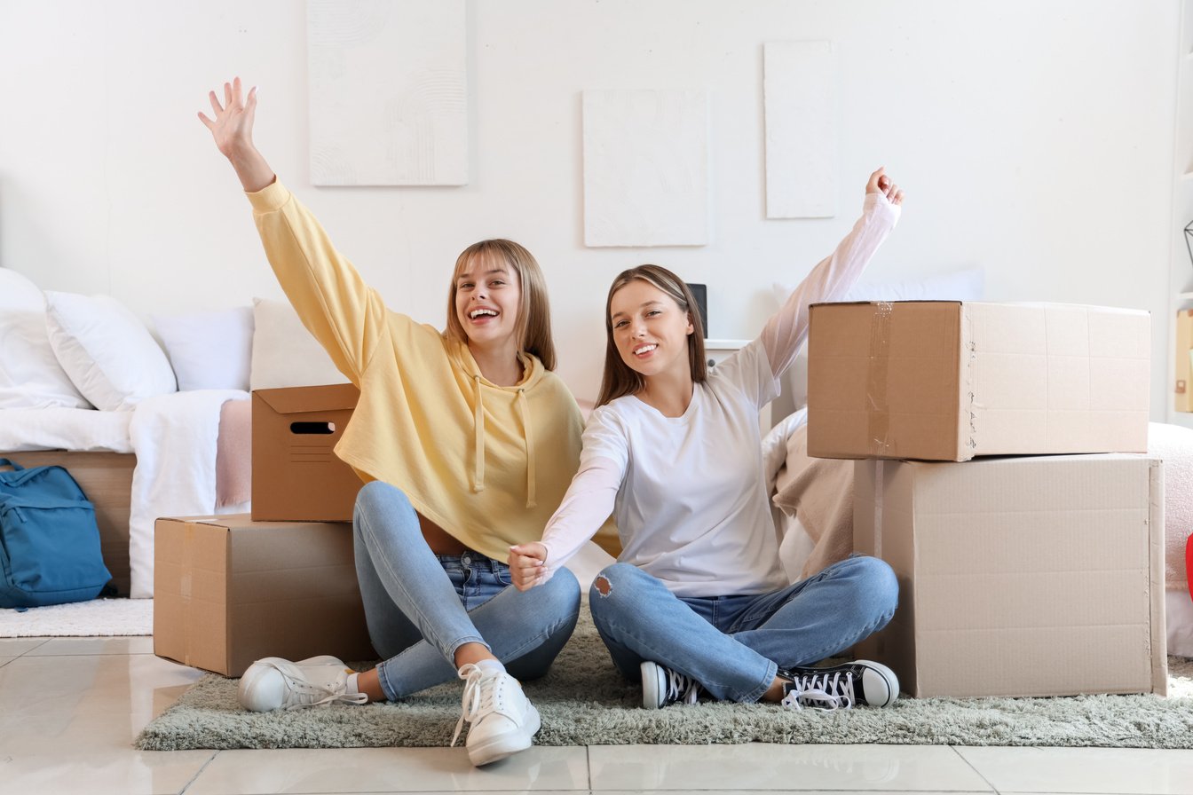 Female Students with Boxes in Dorm Room on Moving Day